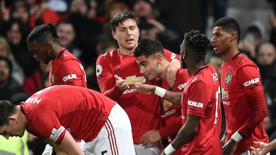 Manchester United's Swedish defender Victor Lindelof (C) celebrates with teammates after scoring an equaliser to make it 2-2 against Aston Villa. AFP