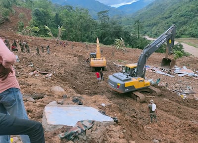 Rescuers use excavators to clear debris after a landslide hit a railway yard in Manipur's Noney district. EPA