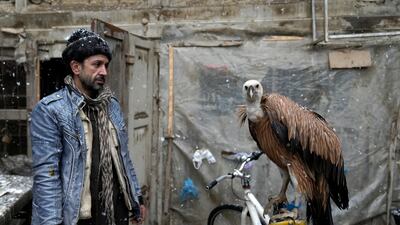 A bird trader sells a vulture at a bird market during snowfall in Kabul, Afghanistan. AP