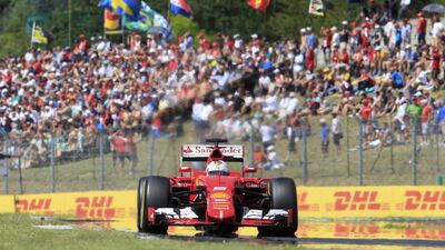 Ferrari Formula One driver Sebastian Vettel of Germany during the Hungarian F1 Grand Prix at the Hungaroring circuit, near Budapest, Hungary July 26, 2015. REUTERS/Bernadett Szabo TPX IMAGES OF THE DAY