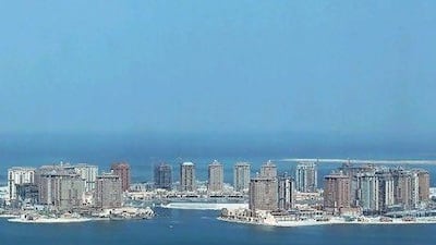 DOHA, QATAR - OCTOBER 28: New highrise office buildings, hotels and apartment buildings, many of them still under construction, stand on the man-made peninsula called The Pearl on October 28, 2010 in Doha, Qatar. The International Monetary Fund (IMF) recently reiterated its projection for the Qatari economy with predictions of double digit growth for 2010 and 2011. Though natural gas and petroleum production are still the biggest two single sources of income, the non-energy sector overtook oil and gas in Qatari GDP for 2009. (Photo by Sean Gallup/Getty Images) *** Local Caption *** GYI0062241230.jpg