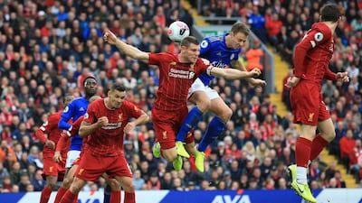 Liverpool's James Milner and Leicester City's Jonathan Evans vie for the ball. Associated Press