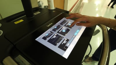 One of the members of staff operates the control panel of the ultrasound machine