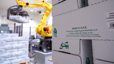 A robotic arm lifts boxes of processed cheese from the automated conveyor system at Pinar and loads them to crates to be delivered. Victor Besa / The National Reporter : Nilanjana Gupta