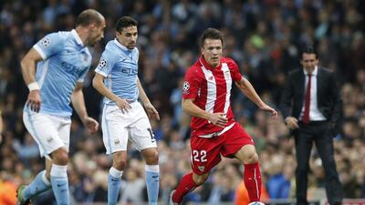 Sevilla’s Yevhen Konoplyanka dribbles by Manchester City’s Jesus Navas during their Champions League contest on Wednesday night. Phil Noble / Reuters