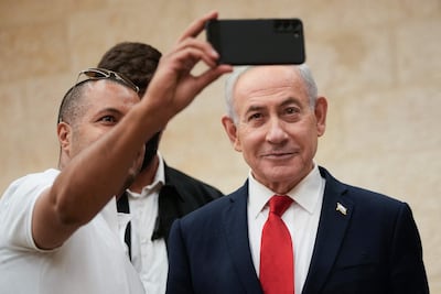 Israeli Prime Minister Benjamin Netanyahu poses for a selfie as he arrives to cast his ballot during primary elections before Israel’s general election in October. AFP