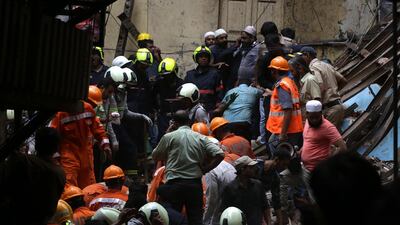 Rescuers work at the site of collapsed building. EPA