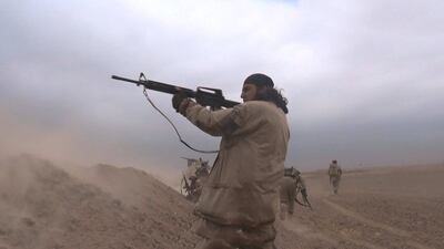 ISIS militants firing automatic weapons during a firefight outside Mosul, near Nineveh, Iraq.