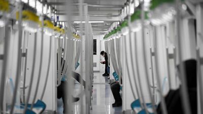 A man wearing a face mask uses his mobile phone on an empty subway train in Beijing. AFP