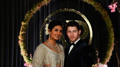 Newlyweds Priyanka Chopra, 36, and Nick Jonas, 26, pose for a photograph during a reception at a hotel in New Delhi on December 4, 2018. Photo: AFP