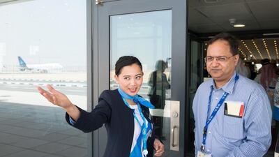 A staff directs a volunteer during the operational trial run of Al Maktoum International Airport. Courtesy Dubai Airports