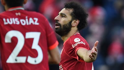 Liverpool's Egyptian midfielder Mohamed Salah celebrates after scoring their second goal during the English Premier League football match between Liverpool and Norwich City at Anfield in Liverpool, north west England on February 19, 2022. (Photo by Oli SCARFF / AFP) / RESTRICTED TO EDITORIAL USE. No use with unauthorized audio, video, data, fixture lists, club/league logos or 'live' services. Online in-match use limited to 120 images. An additional 40 images may be used in extra time. No video emulation. Social media in-match use limited to 120 images. An additional 40 images may be used in extra time. No use in betting publications, games or single club/league/player publications. /