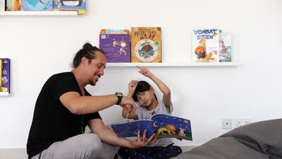 Special education teacher Nikola Vujosevic reads to a pupil in the library of Skills for Kids, a centre newly opened in Dubai. The centre aims to better prepare children with special needs for mainstream education. Pawan Singh / The National