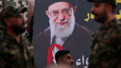 Members of Iraq's Popular Mobilisation Forces in front of a portrait of Iran's former supreme leader Ali Khamenei at the shrine of Imam Hussein in the Iraqi city of Karbala on July 7. AFP