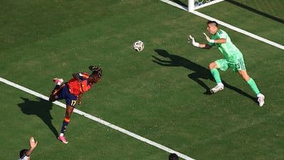 Argentina's Emiliano Martinez saves a shot from Spain substitute Nico Williams. Reuters