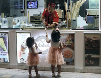 Children enjoy a midnight ice cream at the Al Qasimi Corniche in Ras Al Khaimah. Satish Kumar for The National