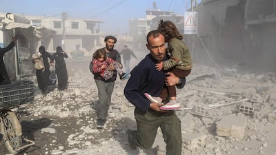 Syrians make their way through debris following a reported air strike in the rebel-held town of Beit Sawa, in the eastern Ghouta region on the outskirts of the capital Damascus, on December 3, 2017. Amer Almohibany / AFP