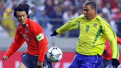 Ronaldo, right, in action against South Korea during a 2002 friendly. In the summer of that year, the Brazilian striker won the World Cup and finished top goal-scorer Kim Jae-Hwan / AFP