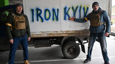 Kyiv Mayor Vitali Klitschko, right, and his brother, Wladimir, stand at a checkpoint on the outskirts of the capital. AFP