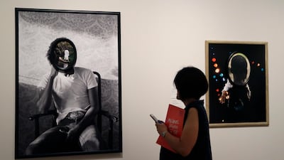 A woman looks at artworks by Todd Gray on display at the "Michael Jackson: On the Wall" at the National Portrait Gallery in London, Britain, on June 27, 2018. Kirsty Wigglesworth / AP Photo