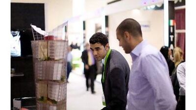 Hisham Bou Habib, right, business development manager at Livescale shows a fellow exhibitor one of Livescale's scale models.