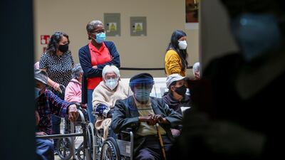 Elderly citizens, some of them accompanied by relatives, wait to be vaccinated against the coronavirus at the Luz Elena Arismendi Hospital in Quito, Ecuador. EPA