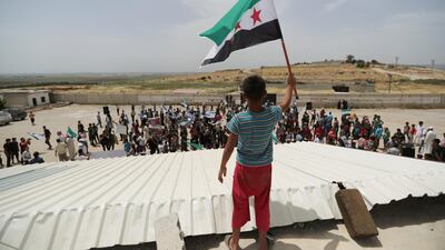 A boy waves a Free Syrian army flag during a protest at the Atmeh crossing on the Syrian-Turkish border, in Idlib governorate, on May 31, 2019. Reuters