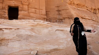 A visitor walks through the ruins of Qasr Al-Bint at the ancient rock heritage site at Al Ula, Saudi Arabia. Saudi Arabia's Crown Prince Mohammed Bin Salman officially launched his vision of the mega tourism project at the ancient site of Al Ula. Bloomberg