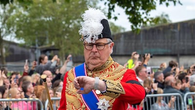 The Duke of Norfolk looks at his watch as Queen Elizabeth II's funeral cortege arrives on the Long Walk in Windsor. Maureen McLean / Alamy Live News