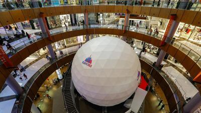 Dubai Mall shoppers can step inside the giant ball in the Star Atrium, walking along a suspended footbridge to the centre of the ball, and experience a fast-paced six-minute film of Dubai shot in 360 degrees. Victor Besa for The National