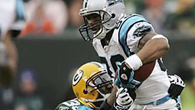 Steve Smith, right, tries to power his way through Nick Collins during the Panthers' win against Green Bay.