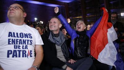 Supporters react after the announcement of French National Front political party leader and candidate Marine Le Pen results during the first round of the regional elections at a polling station in Henin-Beaumont, France on December 6.