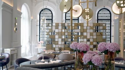 Flowers in vases sit in the La Dame de Pic restaurant at the Raffles Hotel. Bloomberg