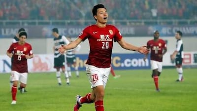 Gao Lin, centre, celebrates after scoring a goal against Thailand's Muangthong United for China's Guangzhou Evergrande in their Group F match of the Asian Champions League.