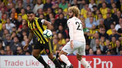 Marouane Fellaini, right, challenging for the ball with Troy Deeney, was credited by Jose Mourinho by being vital to his side's 2-1 victory at Watford. Ross Kinnaird / Getty Images