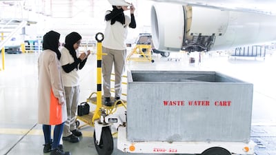 An engineering team assesses dents in the drain mast forward of an Etihad aircraft at Etihad Airways Engineering's facilities in Abu Dhabi Reem Mohammed/The National
