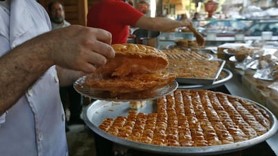 Syrian vendors prepare and sell traditional sweets during Ramadan in the Midan neighbourhood of Damascus, Syria. AFP