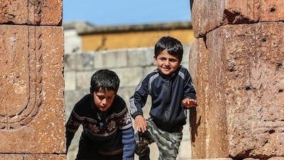 Children sit on one of the apse's windows. AFP