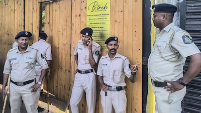 Police stand guard outside the nightclub. State authorities have ordered an investigation into the blaze. AFP