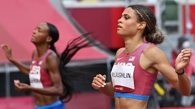 USA's Sydney Mclaughlin reacts as she crosses the finish line past USA's Dalilah Muhammad.