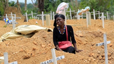 A woman mourns at her father's grave at Disco Hill Cemetery in March 2016. Decoration Day is observed on the second Wednesday of March in Liberia to honour and remember the dead. Ahmed Jallanzo / EPA