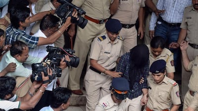 Indian police are surrounded by media as they escort former media executive Indrani Mukherjea from a city court in Mumbai on August 31. AFP Photo