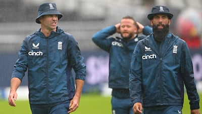 England players James Anderson, Ben Duckett and Moeen Ali in the rain at Old Trafford. Getty
