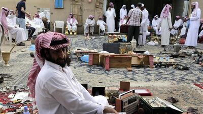Dusty metal jewellery sits in piles inside woven baskets for buyers to rummage through and then bid.