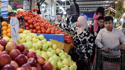 Shoppers at a fruit and vegetable stall in Amman. AFP