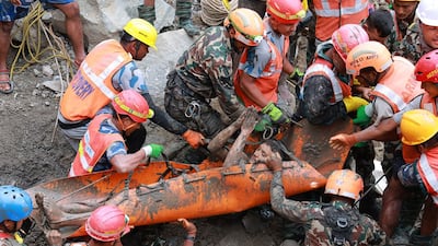 Army personnel rescue a worker who had been trapped inside a tunnel linked to a hydropower station for nine days, after the deadly mudslide and flash floods, in the Rasuwa district of Nepal. AFP