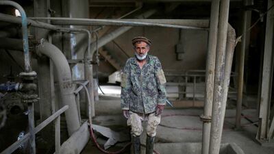 Worker Dadullah stands in for a photo.
