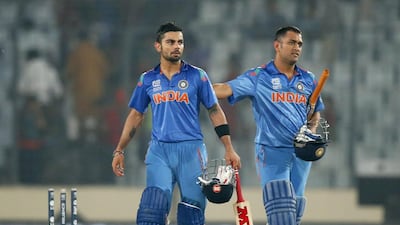 MS Dhoni, right, and teammate Virat Kohli helped India to an eigh-wicket win over Bangladesh on Friday night. Aijaz Rahi / AP Photo
