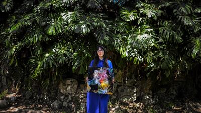 Argentine artist Sofia Crespo holds one of her works as she poses for a photo at the Estrela garden in Lisbon on June 8, 2022. AFP