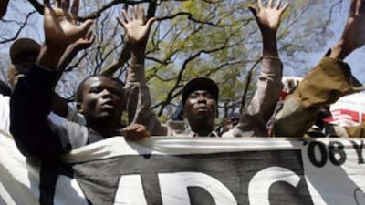 Zimbabwean opposition Movement for Democratic Change (MDC) supporters cheering their deputies on August 26, 2008 during the opening of 7th parliament of Zimbabwe, which is dominated by the opposition. Zimbabwean President Robert Mugabe was heckled by the opposition as he opened parliament and declared that "landmark agreements" were expected to be signed by the country's political rivals.